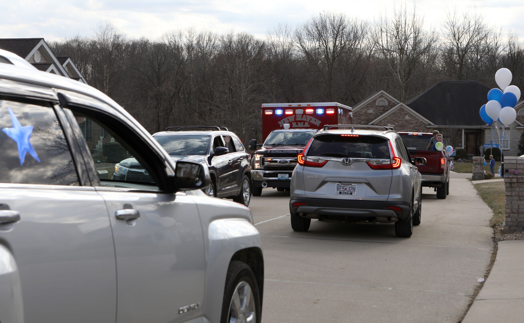 Cars file past the Wilson's home
